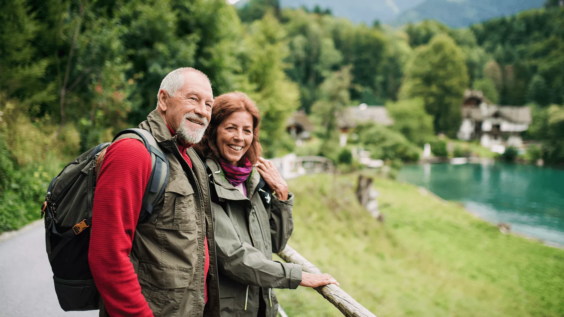 Een ouder koppel geniet van een wandeling in een schilderachtig landschap.